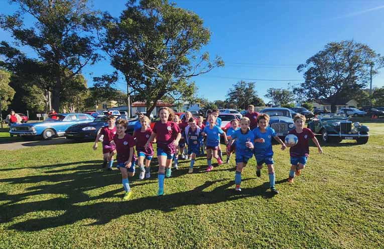Kids taking to the field from the car display during the Myall Motor Club round.