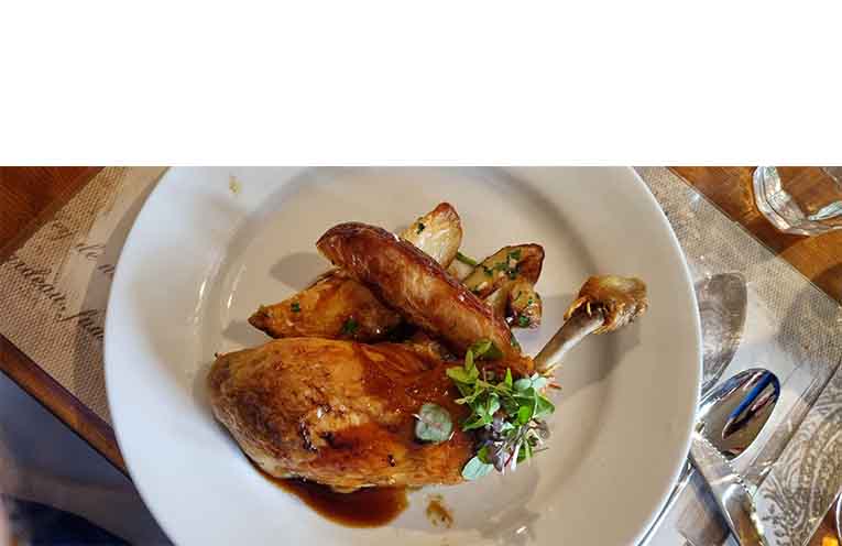 The main event: confit chicken with divine sarladaise potatoes. Photo: Thomas O’Keefe.