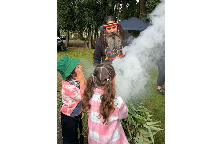 Uncle Justin Ridgeway with children Connor and Charli during the smoking ceremony. Photo: Rachel Barry.
