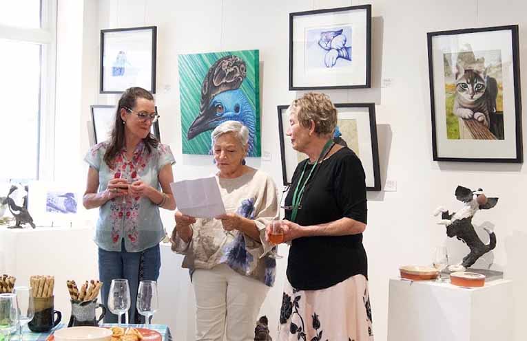Jade and Chez with Emilie Tseronis, from Tea Gardens Galleries in the Gardens, at the exhibition in Newcastle. Photo: Supplied.