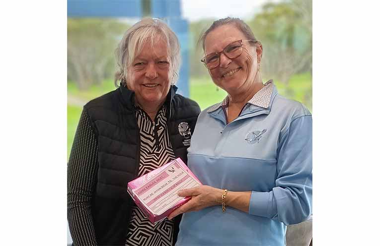 Carolyn Affleck receives the Eagle's Nest prize from vice captain Tanya Sinclair.