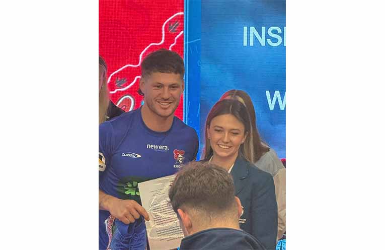 Students from Catherine McAuley Catholic College, Medowie present Newcastle Knights players with their hand-painted boots honouring Indigenous Round. Photos: CMCC Facebook.
