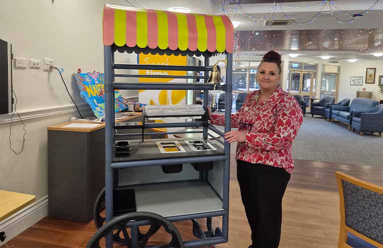 Recreation and Engagement coordinator Cindy Gam with the ice cream cart residents helped to design and colour-coordinate. Photo: Christine Rayner.