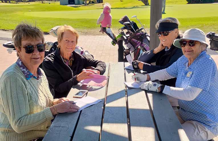 Lady Vets Chris, Di, Sue and Kate check their scores under the watchful eye of Gloria.