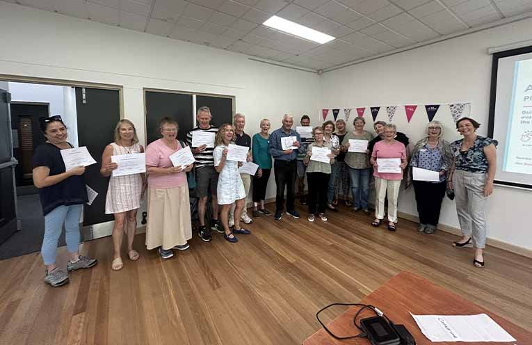 A full house of 18 participants with their certificates of completion.